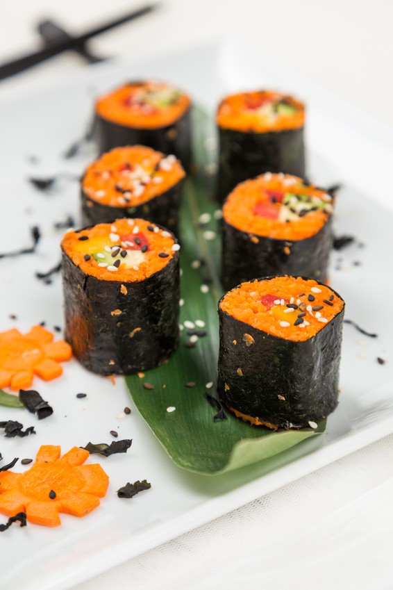 serving fresh raw vegetarian rolls with carrot