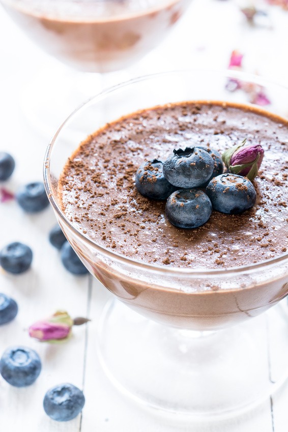 Cllose up of fresh chocolate mousse with blueberries